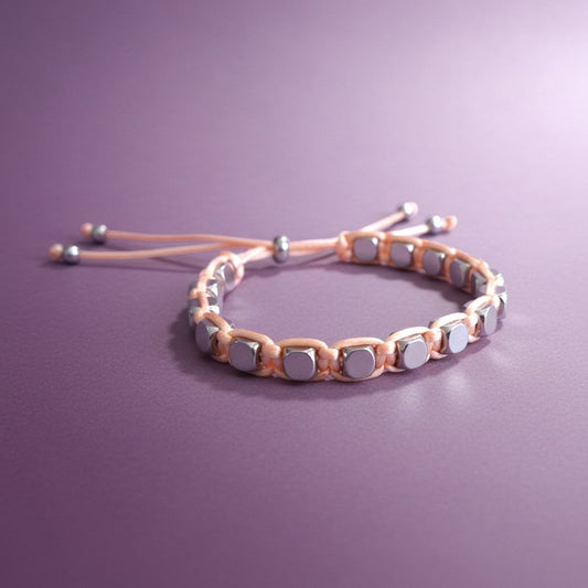 Made by Mothers Stella Aura bracelet with silver stainless steel beads on a pale pink silky satin adjustable cord.