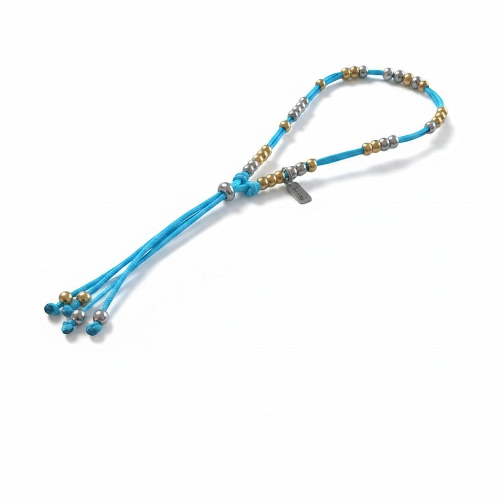 Made by Mothers The Luna Anklet featuring a bright blue satin cord with hypoallergenic gold and silver beads.