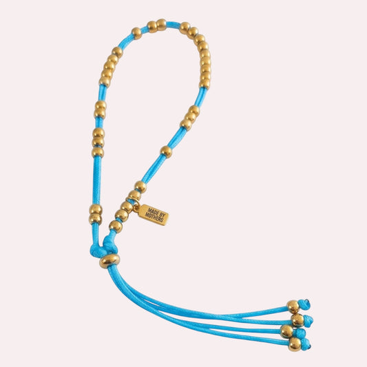Made by Mothers Luna anklet with vibrant blue satin cord and hypoallergenic gold stainless steel beads