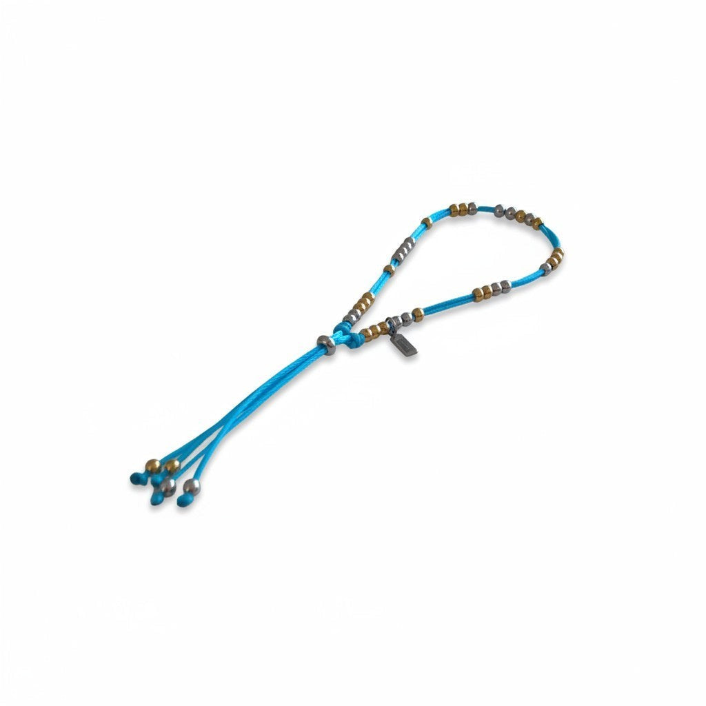 Made by Mothers Luna anklet with blue satin cord and hypoallergenic stainless steel beads, waterproof design.