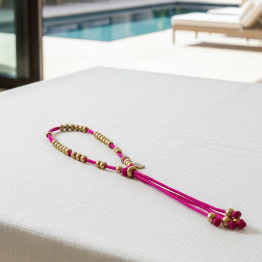 Made by Mothers Luna anklet with vibrant pink satin cord and hypoallergenic gold stainless steel beads.