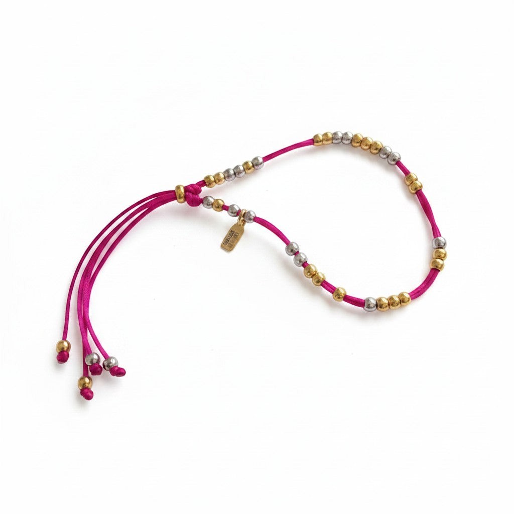 Made by Mothers Luna anklet featuring a vibrant pink satin cord with hypoallergenic gold and silver stainless steel beads.