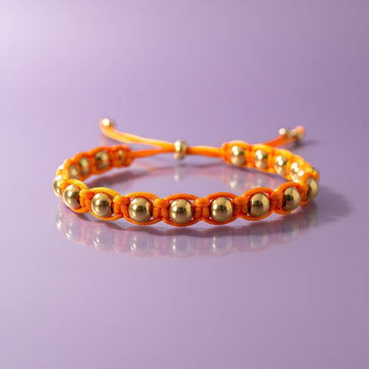 Made by Mothers orange satin cord bracelet with gold stainless steel beads, adjustable size, waterproof.