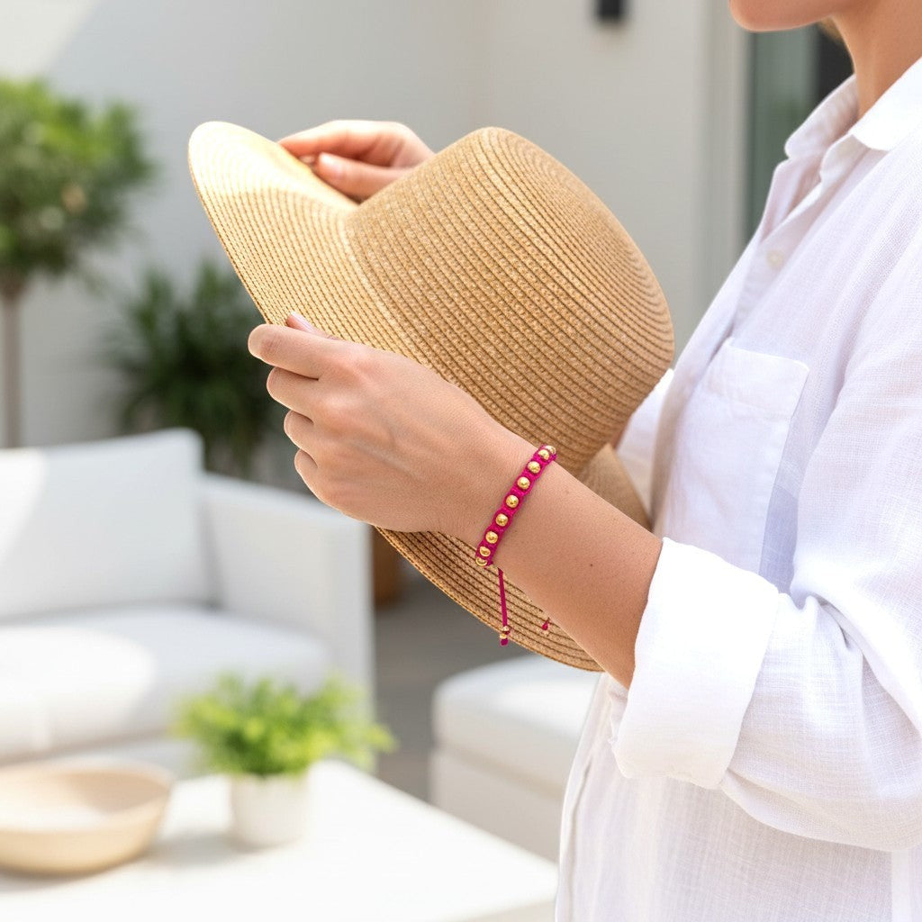 Made by Mothers pink satin cord bracelet with gold stainless steel beads, adjustable, waterproof.