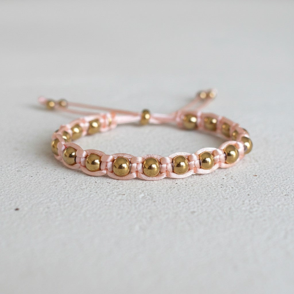 Made by Mothers pink satin cord bracelet with gold stainless steel beads, adjustable size.