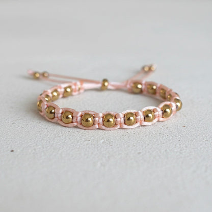 Made by Mothers pink satin cord bracelet with gold stainless steel beads, adjustable size.