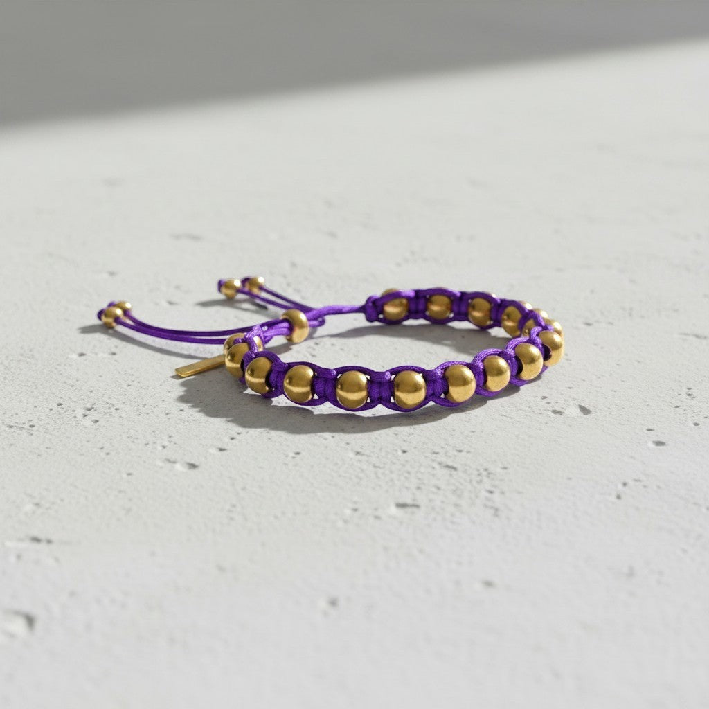 Made by Mothers purple satin cord bracelet with gold stainless steel beads and adjustable tie closure.