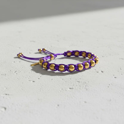 Made by Mothers purple satin cord bracelet with gold stainless steel beads and adjustable tie closure.