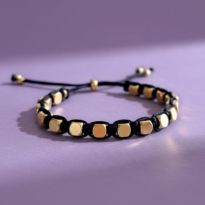 Made by Mothers Stella Aura adjustable bracelet with gold stainless steel beads on a black silky satin cord.