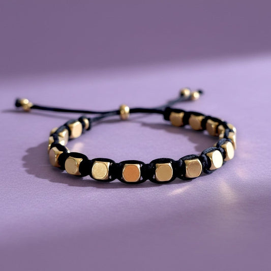 Made by Mothers Stella Aura adjustable bracelet with gold stainless steel beads on a black silky satin cord.