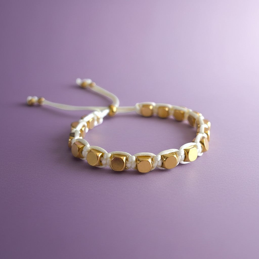 Made by Mothers Stella Aura adjustable bracelet with gold stainless steel beads on a white silky satin cord